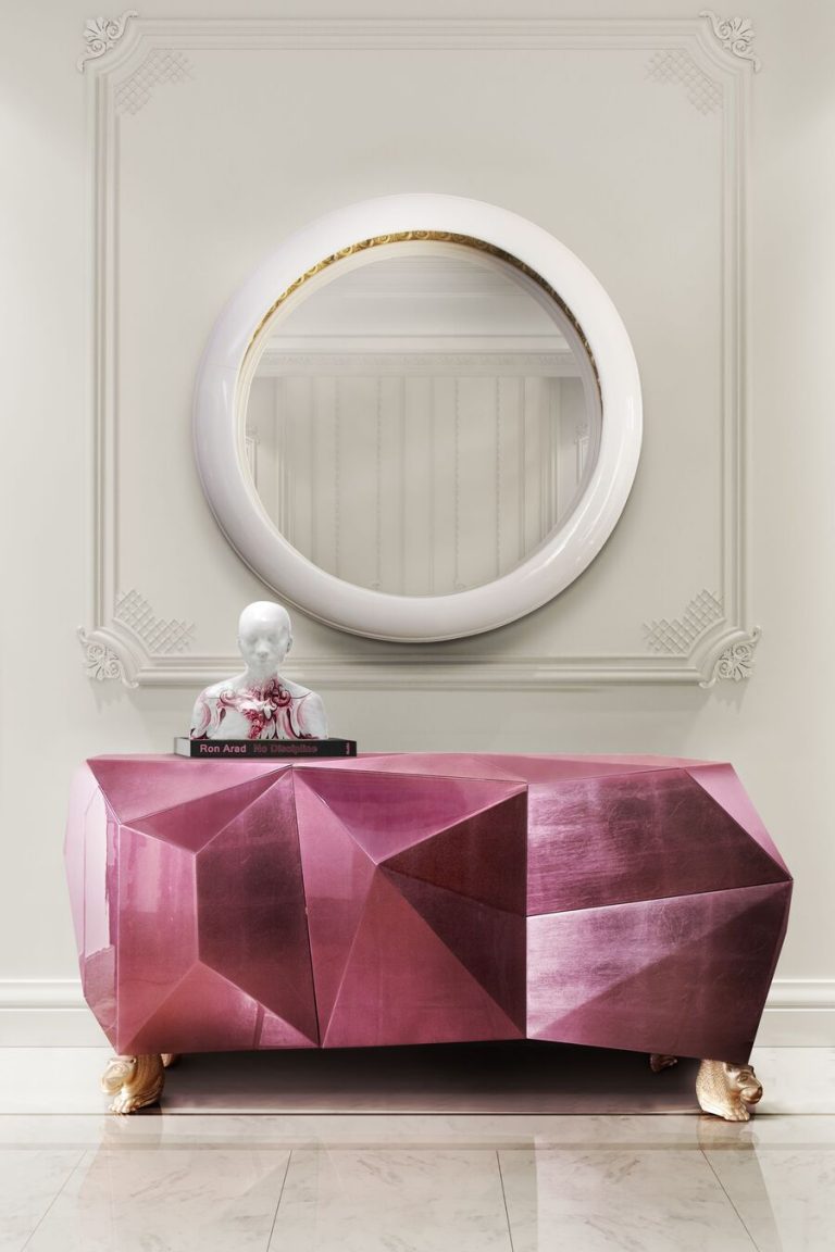 pink diamond console table with a white round mirror